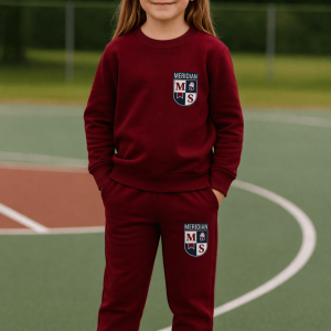 Child wearing a maroon Meridian school uniform standing on an outdoor sports court.